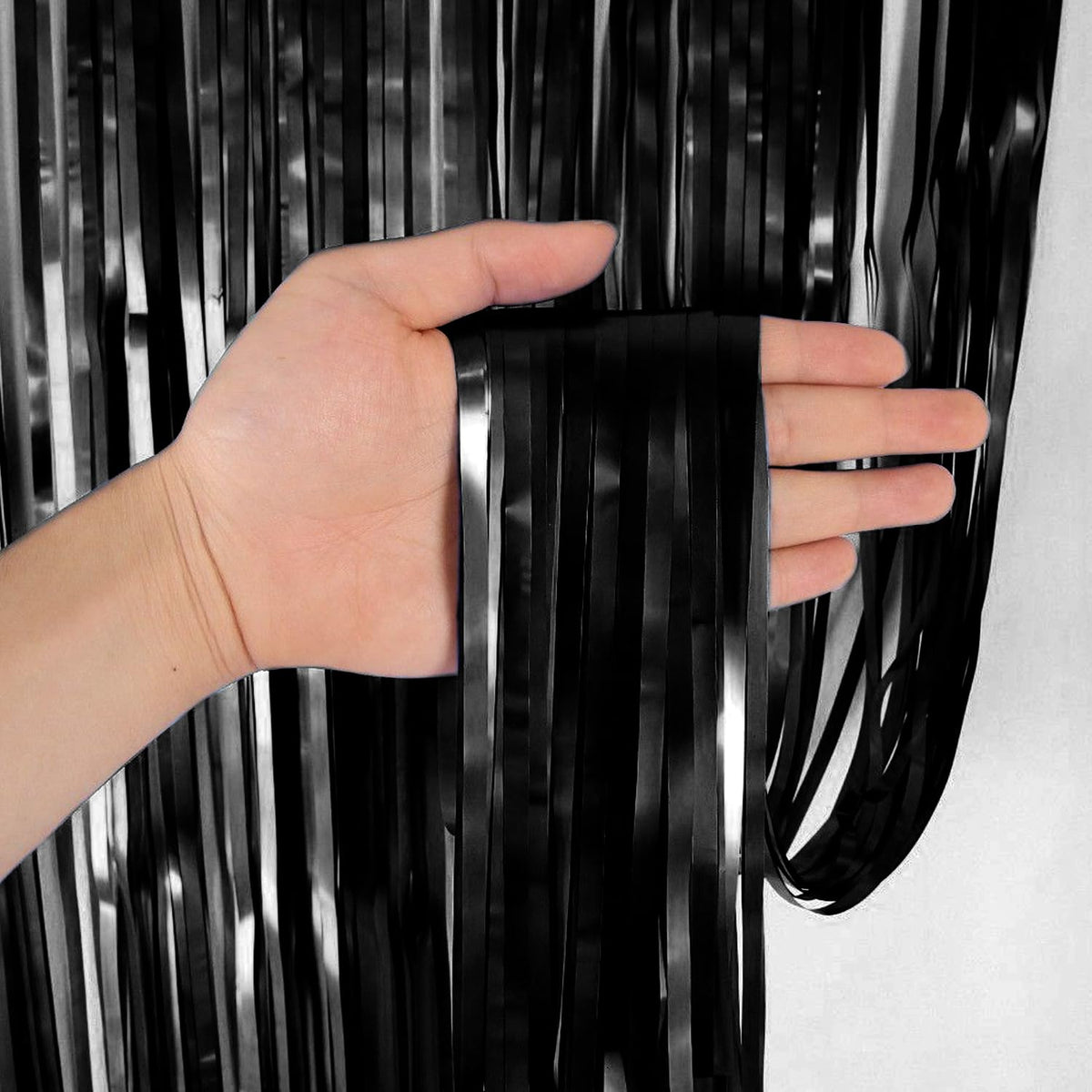 Black foil curtain backdrop for birthday and party decoration with metallic fringe design